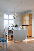 Drop-leaf table and yellow dresser in dining room