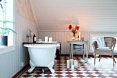 Candlelit, attic bathroom with chequered floor