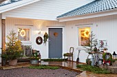 Christmas decorations outside white wooden house