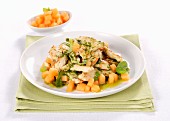 Herb-coated chicken with melon