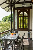 Sommerliche Loggia in Fachwerkhaus mit Rundbogenfenster