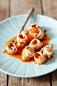 Herring rolls with onion and a spicy tomato sauce
