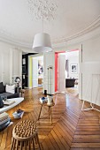 Stucco ceiling and retro ambiance in living room of renovated period apartment