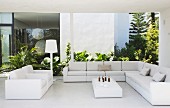 Outdoor living room with white sofa on roofed terrace