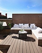 Elegant benches with white cushions and cushions on sunny roof terrace