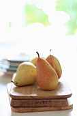 Four pears on a wooden board