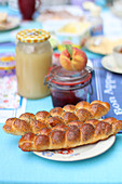 Yeast plaits with poppy seeds on the breakfast table