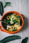 Pasta soup with kale, savoy cabbage and bay leaves