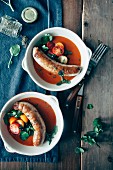Prawn bisque with sausages, tomatoes and herbs