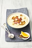 Creamy potato soup with duck breast, apple and croutons