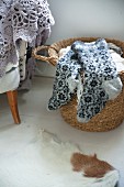 Thick woollen socks with Norwegian pattern lying on basket