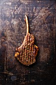 Grilled beef barbecue Veal rib on dark metal baking sheet background