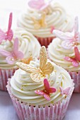 Cupcakes decorated with pink and gold fondant butterflies