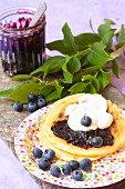 Pancakes with blueberry jam and cream
