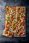 Pizza with aubergine and pesto in a baking tray