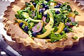 Avocado salad with rocket, onion, blueberries and oranges