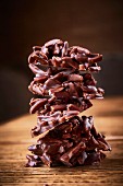 A stack of circles of slivered almonds in chocolate