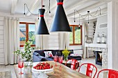 Open interior of white wooden house with red accents