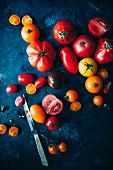 Assorted tomatoes on a dark surface