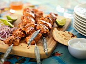 Spicy chicken kebabs with flatbread and lime