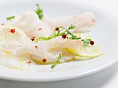 Fish carpaccio with lemons and red peppercorns