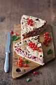 Slices of redcurrant & almond tart on a wooden cutting board