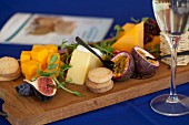 A cheeseboard with biscuits, figs and watercress