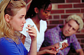Teens smoking behind school
