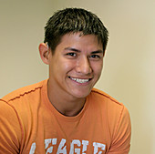 Young deaf latino man with hearing aid