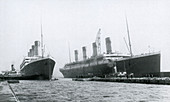 Titanic and Olympic leaving the shipyard