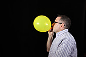 Man Inflating Balloon