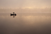 Fisherman on Small Lake in Fog,USA