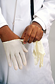Doctor putting on gloves