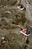 People buried in hot sand