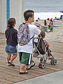 Parents and Child Stroll on Boardwalk
