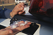 Police Officer Examines Cocaine Bags