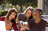 Women Laughing and Looking at iPhone