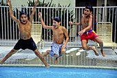 Boys Jumping into Pool