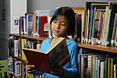 8 year Old Girl in a Library