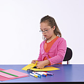 Girl with Special Needs Cutting Paper