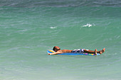 Man floating on an air mattress,Thailand