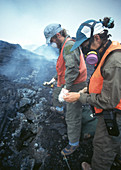 Volcanologists using a thermocouple