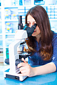 Woman using microscope