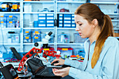 Woman working on a robotic arm