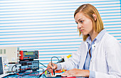 Female electrical engineer working in lab