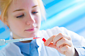 Lab technician holding test tube