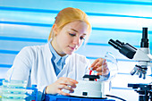 Lab technician holding sample in lab