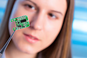 Female electrical engineer with chip