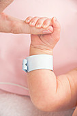 Newborn baby gripping parent's finger