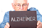 Man holding board with Alzheimer on it